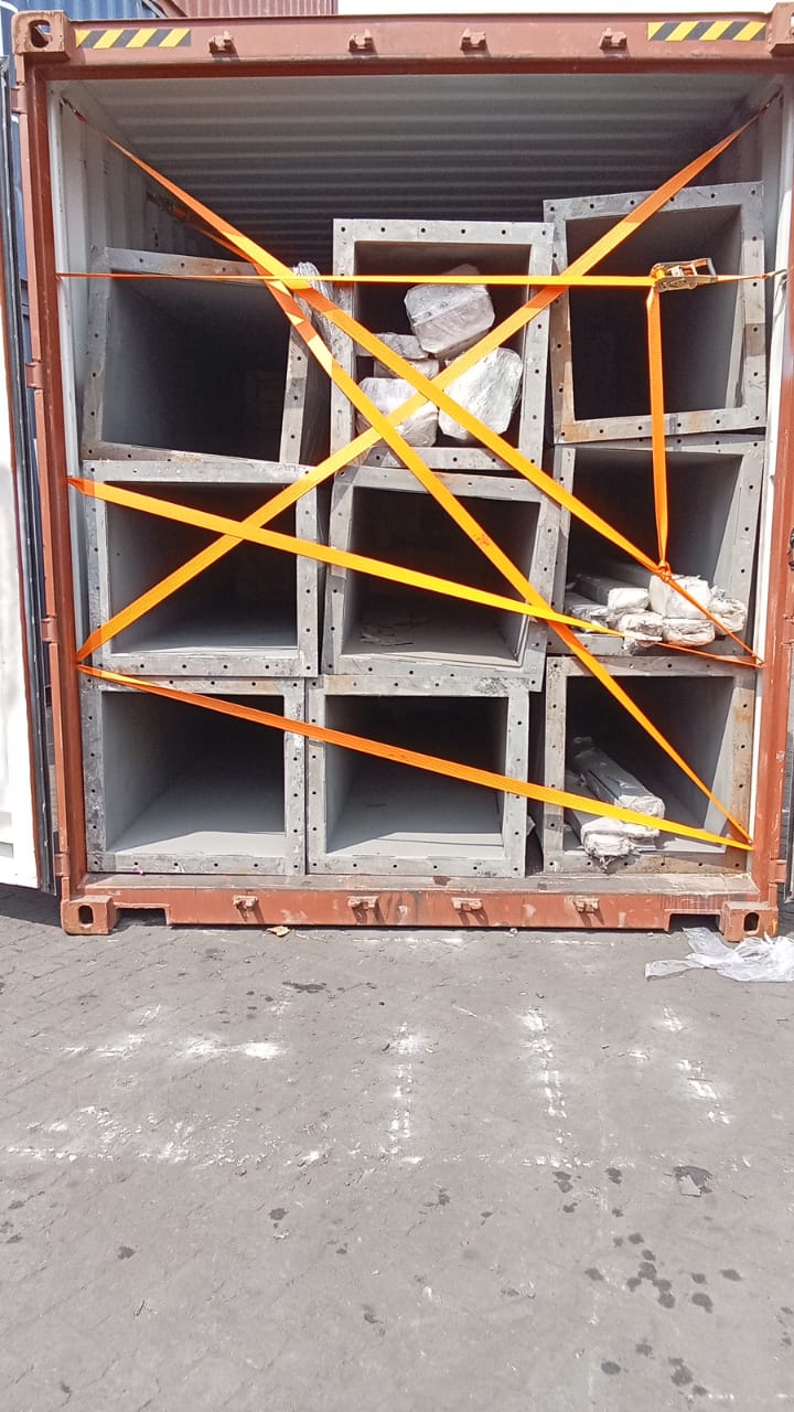 Steel box sections braced with ratchet straps inside a container