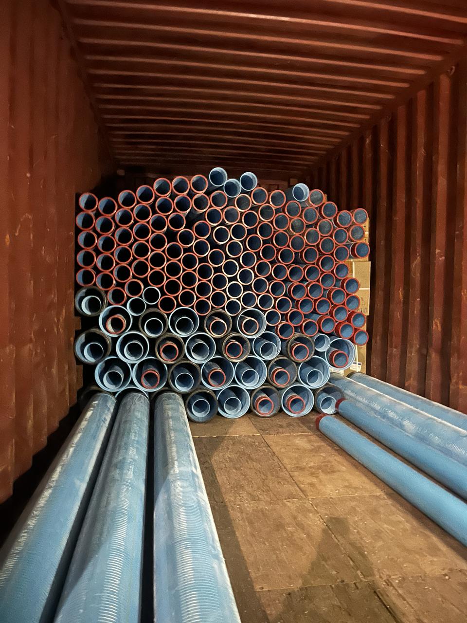 PVC pipes loaded end-on inside a container