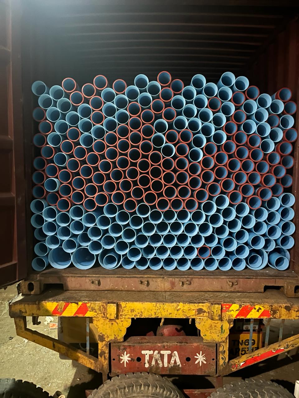 PVC pipes stuffed into a container on a truck